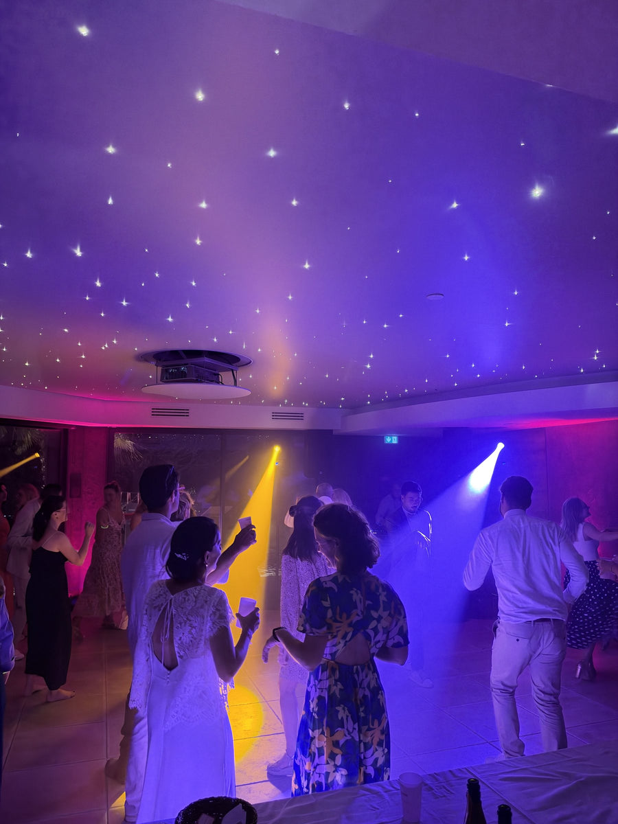 Piste de danse sous un plafond étoilé, faisceaux de lyres